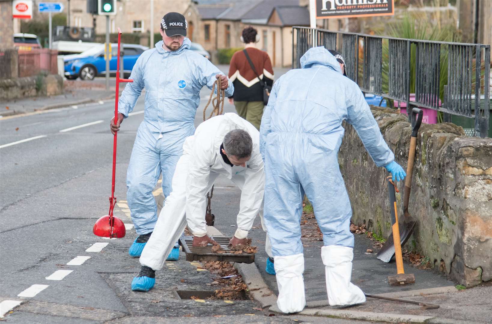 Checking drains on School Brae Place.
