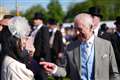 Charles appears in good spirits with guests at Buckingham Palace garden party