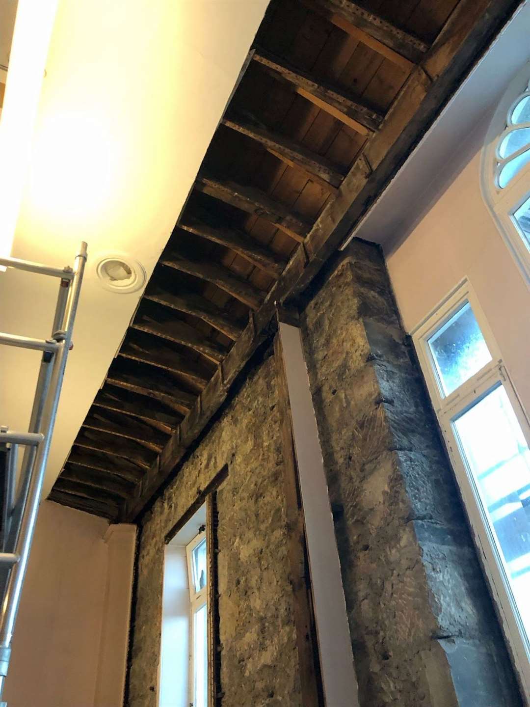 The long support (pictured) is short of the beam at the front of the building. Scaffolding has been used for support while the beam is replaced.