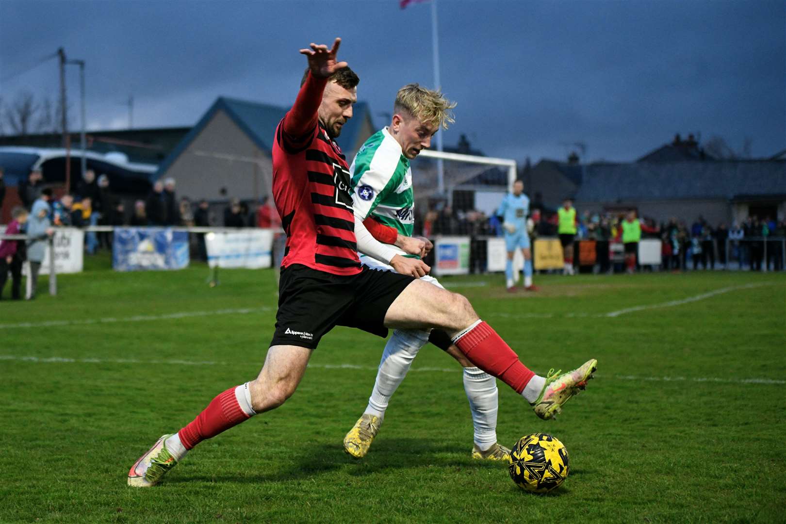 Mark Souter gets a challenge in on Buckie's Jack MacIver. Picture: Daniel Forsyth