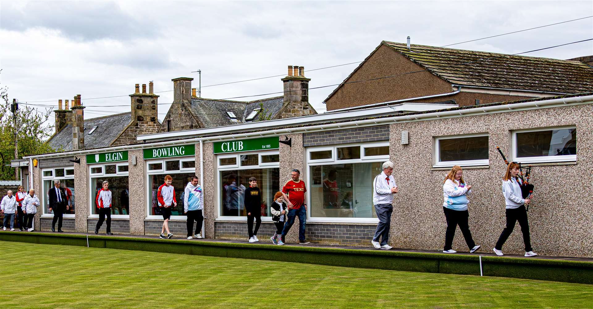 Bronagh Gillies pipes the members out to the green for the grand opening.