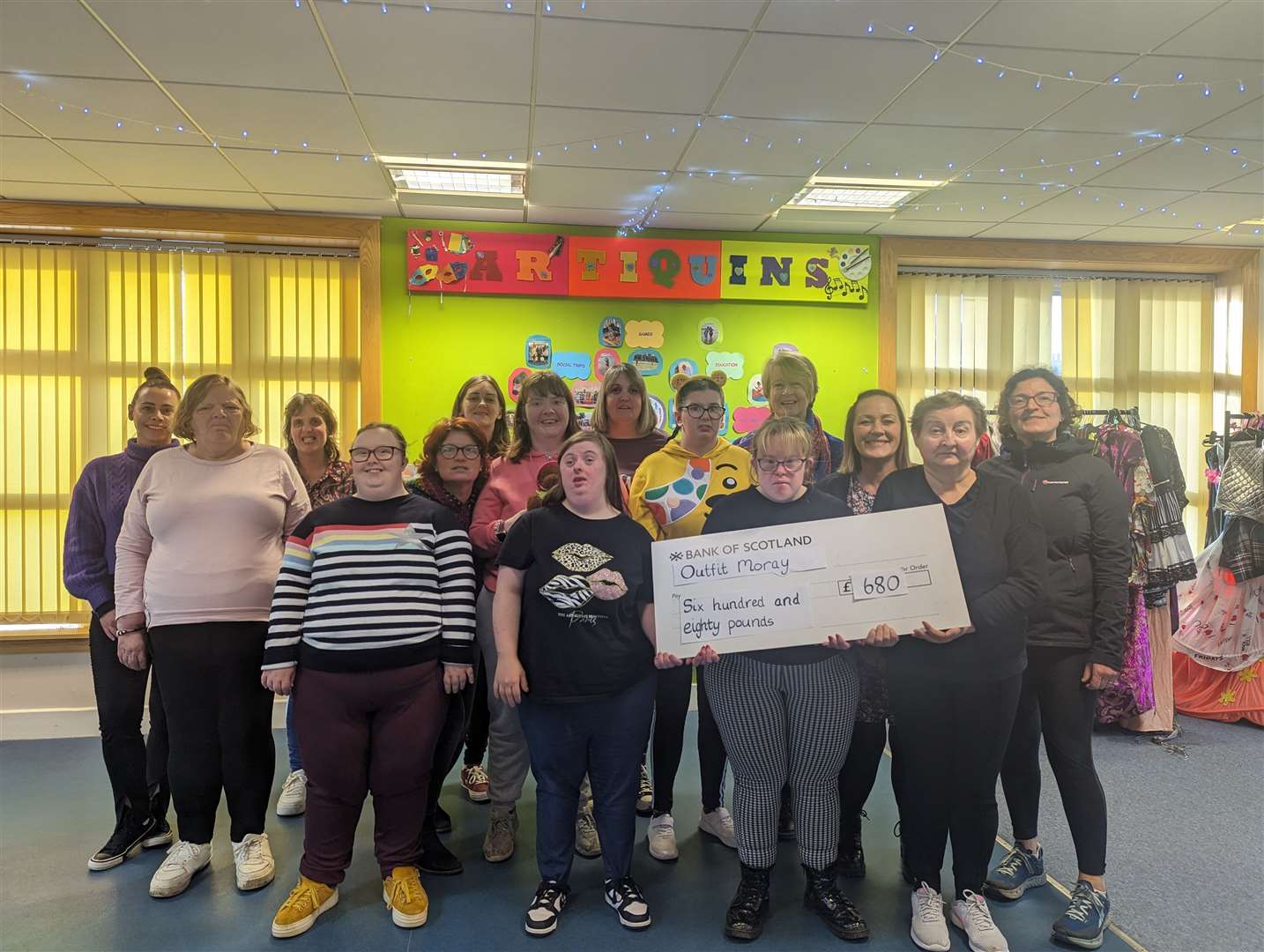 Artiquins with a cheque for the money they raised.