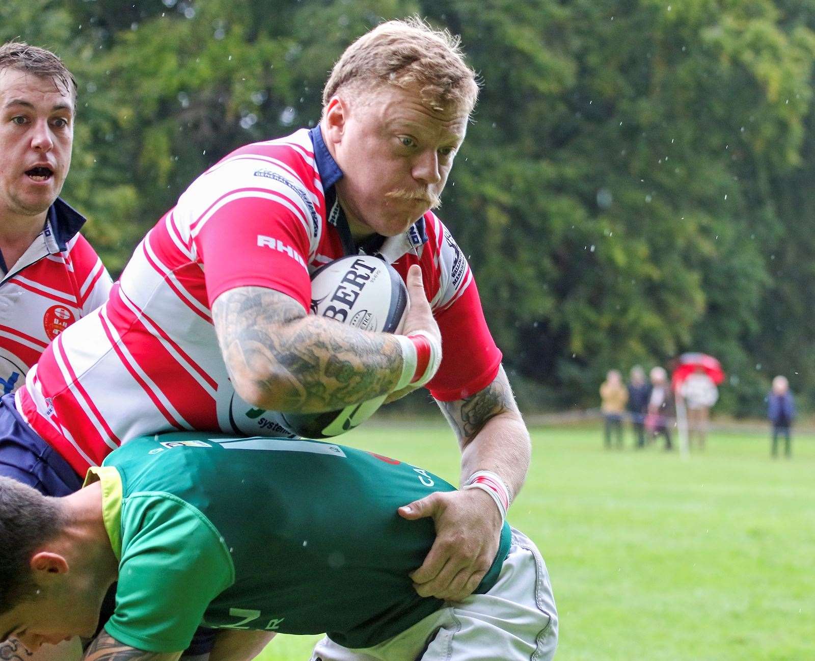 Lewis Scott being tackled. Cameron Hughes in b/g